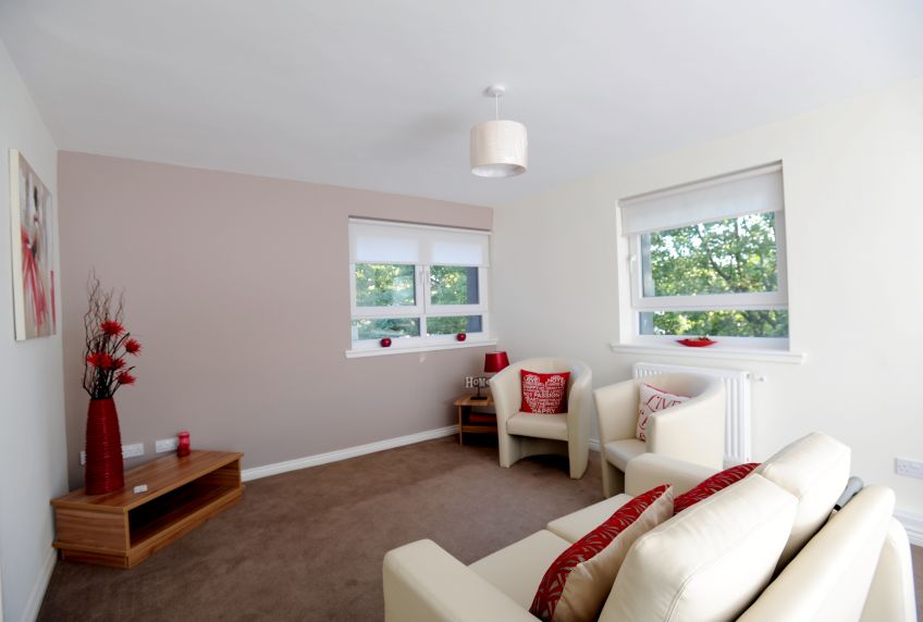 Living room with two chairs, a sofa and decor