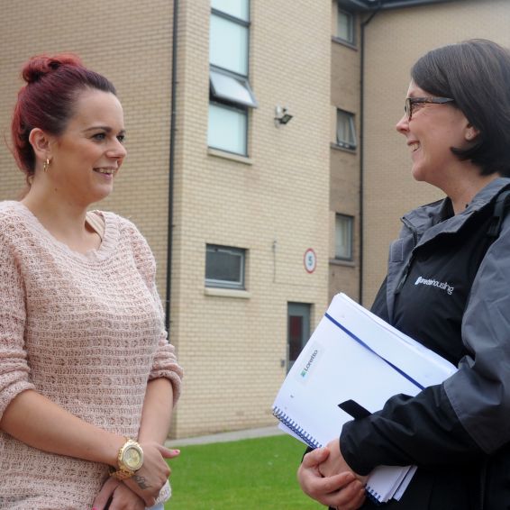 Housing Officer Claire Latto chats with a Loretto tenant