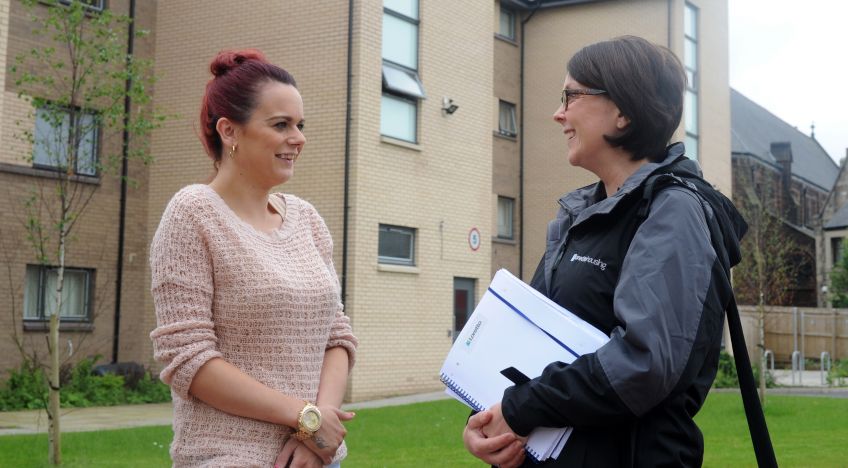 Housing Officer Claire Latto chats with a Loretto tenant