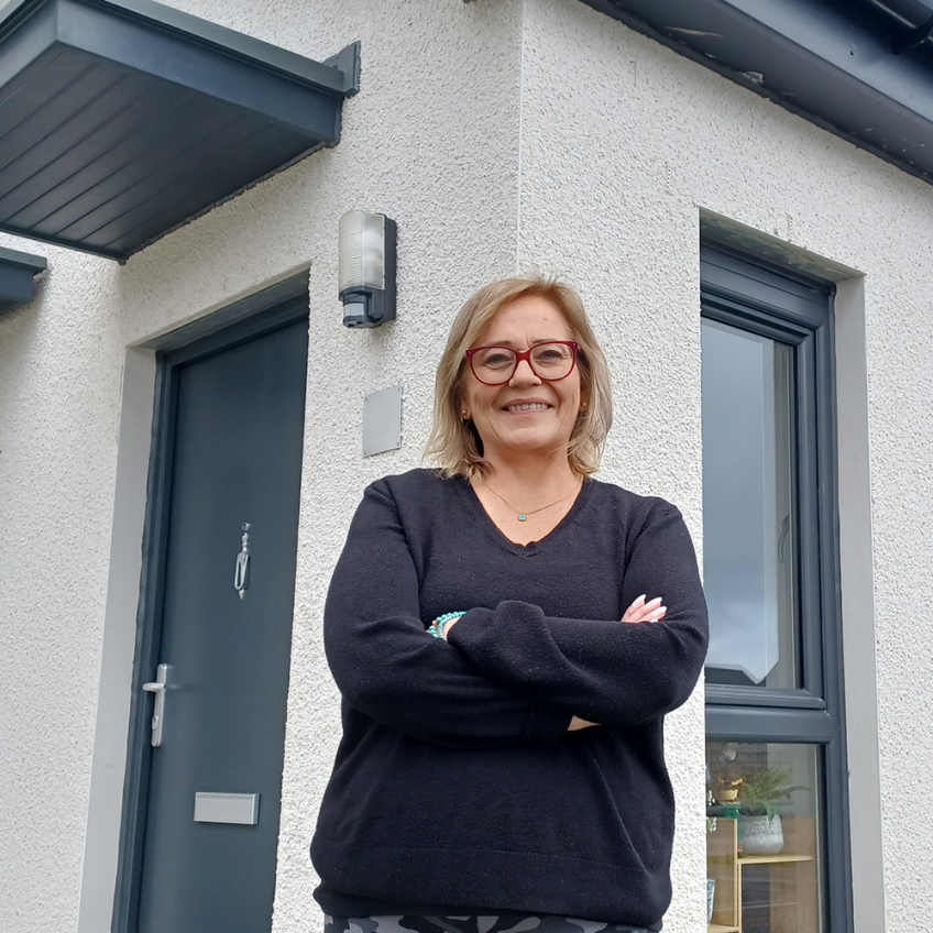 Tenant standing outside her home